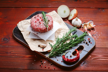 fresh raw cutlets for burger from beef. wooden background, rustic style.