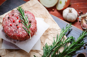 fresh raw cutlets for burger from beef. wooden background, rustic style.