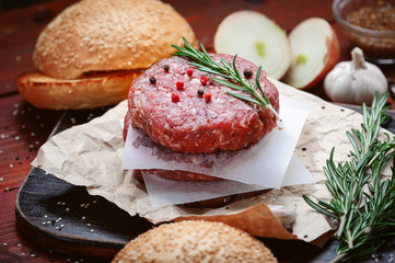 ingredients for a delicious homemade American burger with a juicy large beef chop
