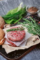 ingredients for a delicious homemade American burger with a juicy large beef chop