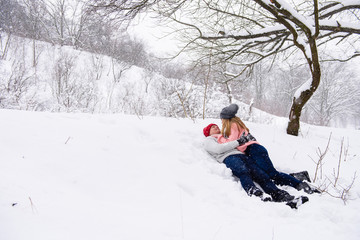 Winter landscape with a couple laying in snow