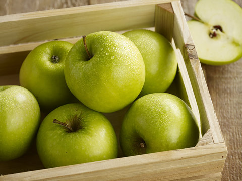 Green apples in crate