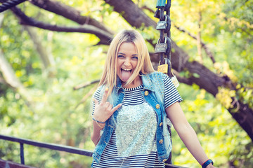 Expressive rebel girl making face in nature