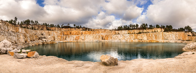 Blue lake in mining industrial crater, acid mine drainage in rock,Spain.