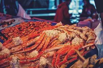 A large showcase with claws and parts of the North sea crab and shrimp on the counter of the...