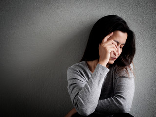 Depressed broken hearted woman sitting alone in dark room at home. Lonly , sad, LOVE and ...