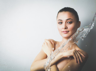 Naklejka premium Young beautyful woman under shower in bathroom.