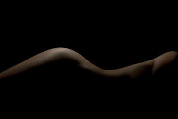 Silhouette of a body part , nude woman isolated on black background