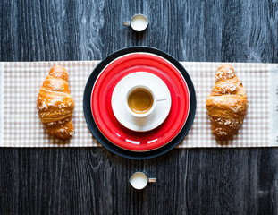 Top view of a wood table full of cakes, fruits, coffee, biscuits, spices and more