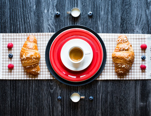 Top view of a lot of classic sweet food like cakes, brioches and biscuits with fruits and coffee