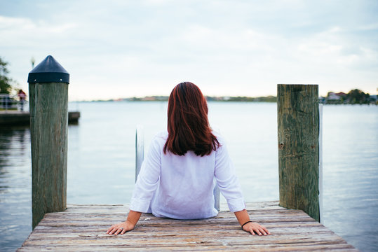 Girl sitting on a dock