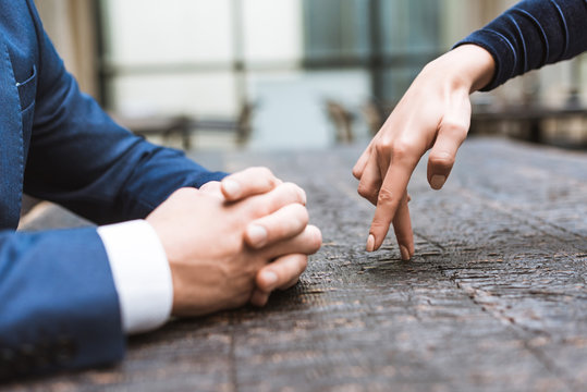 cropped shot of woman making steps with figers to her boyfriend