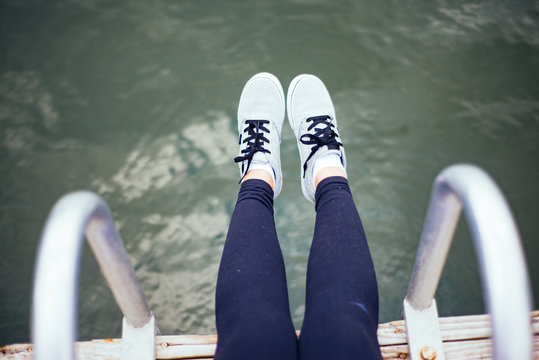 A girl sitting on a dock