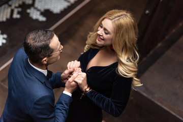 high angle view of beautiful adult couple holding hands