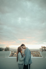 Fototapeta na wymiar Young lovers kissing in a beautiful sunset. Valentine's Day
