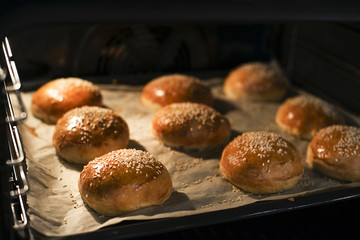 Tasty buns with sesame. Freshly Baked Buns. Hot, fresh from the oven hamburger buns. Homemade...