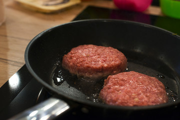 Frying raw home-made beef burger cutlet