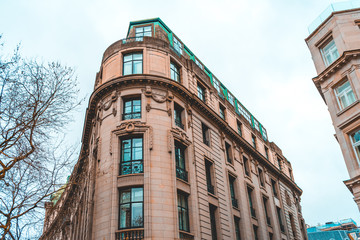 Fototapeta na wymiar orange curved real estate corner building in london
