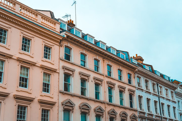 orange, pink and white facaded real estate houses in london