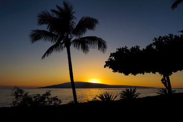 Sunset over Lanai from Baby Beach on the island of Maui.