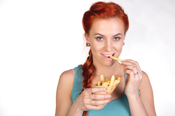 portrait of  young woman eating  french fries