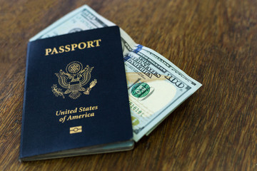 Blue American passport with money on a table