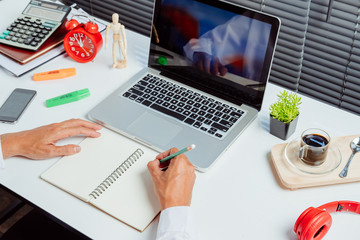 Businessman hands with pen writing notebook