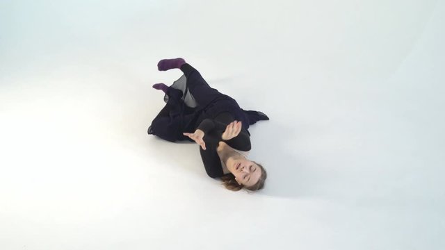 young woman dancer dancing on white isolated background. White background, black clothes. contrast video. Contemporary choreography in Contemporary style 4k