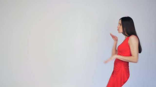 Ridiculous, funny dancing woman in red dress passing by