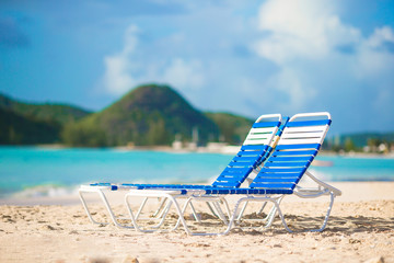 Beach lounge chairs on a beautiful tropical beach on Caribbean