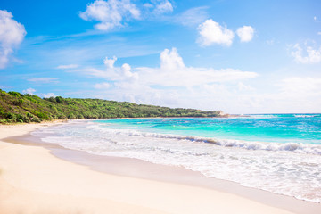 Naklejka na ściany i meble Idyllic tropical beach with white sand, turquoise ocean water and blue sky on Caribbean island