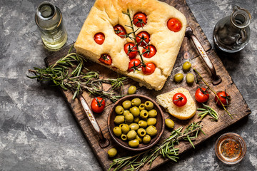 Focaccia with fresh cherry tomatoes, olives and rosemary