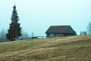 Mountain landscape in the fog. house in the mountains. Carpathian mountains.