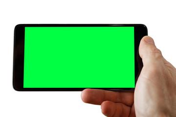 Human hand holding smartphone with empty screen to take a photo. Empty green blank mockup isolated on white.