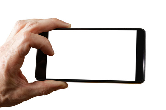 Human hand holding smartphone with empty screen to take a photo. Empty white blank mockup isolated on white.