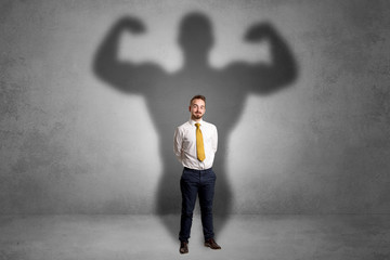 Businessman with muscular shade behind his back