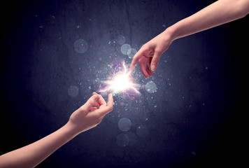 Hands reaching to light a spark