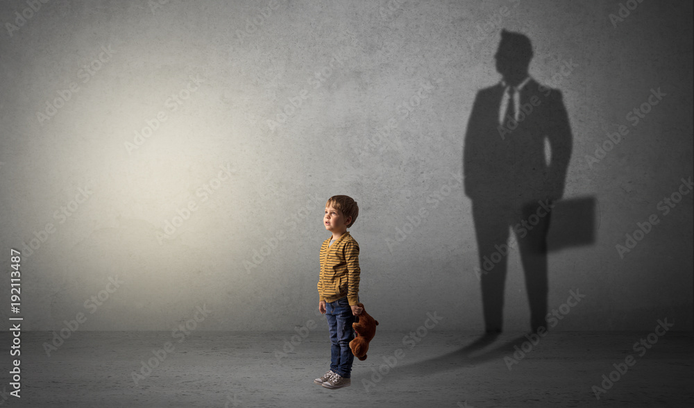 Wall mural little boy with businessman shadow