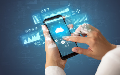 Hand using phone with financial tracking concept