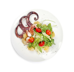 Plate of tasty warm salad with octopus on white background, top view