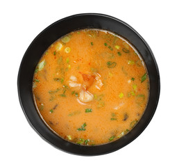 Bowl of tasty Asian soup with shrimps on white background, top view