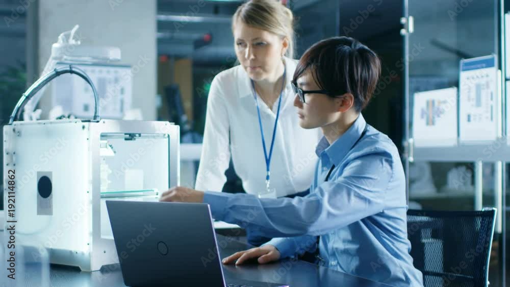 Poster two engineers work with three dimensional printer in laboratory