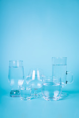 Transparent water in different glasses
