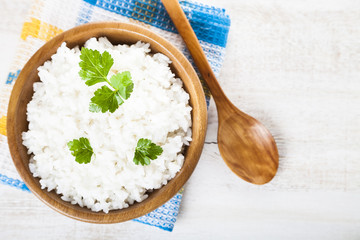 Boiled rice in a wooden bowl and spoon