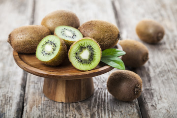 Ripe kiwi in a wooden dish