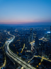 Fototapeta premium Vertical aerial view in the middle of Kuala Lumpur cityscape skyline .Night scene before sunrise , Malaysia .