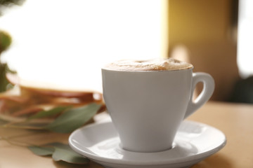 Cup of aromatic coffee for breakfast on table