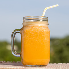 Healthy eating, food, dieting and vegetarian concept - glass mug of juice yellow smoothie shake...