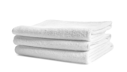 Folded clean terry towels on white background