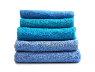 Folded clean terry towels on white background